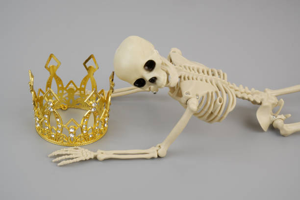 istock Skeleton or death holding gold crown 2161855458