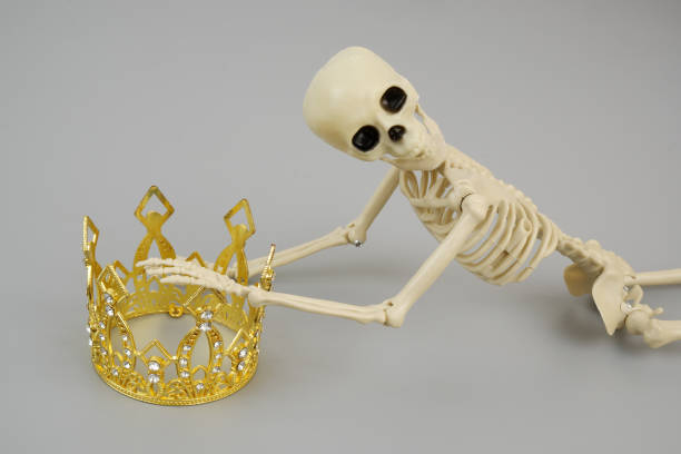 istock Skeleton or death holding gold crown 2161855462