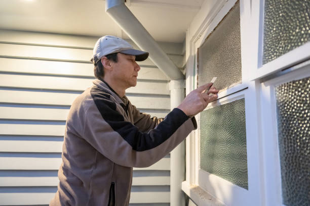 istock Worker applying window putty to a newly replaced glass. Home maintenance project. 2161855500