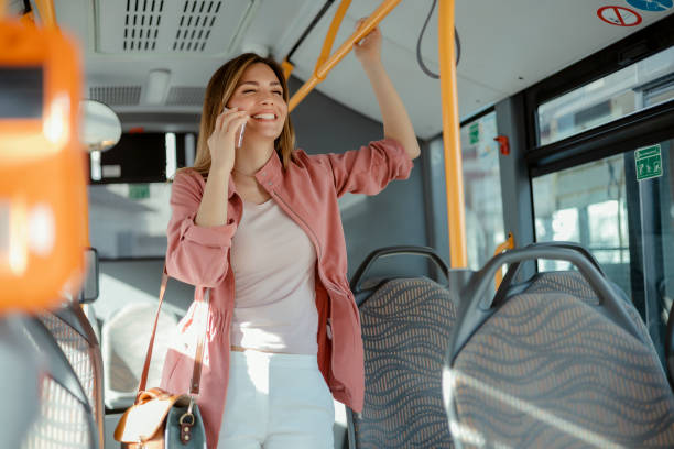 istock Female Talking on Mobile Phone While Commuting by Public Transport 2161855687