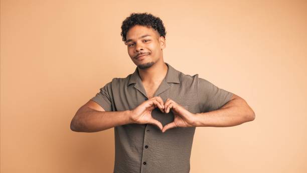 istock Cheerful man making heart shape sign with hands to show affection 2161861017