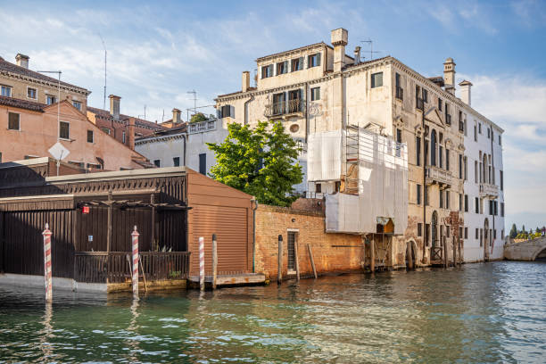 Venice, Italy - June 1st 2024:  Old classic palace utilized as a common residential building in the center of Venice - part of the city's charm is the decay of the old buildings