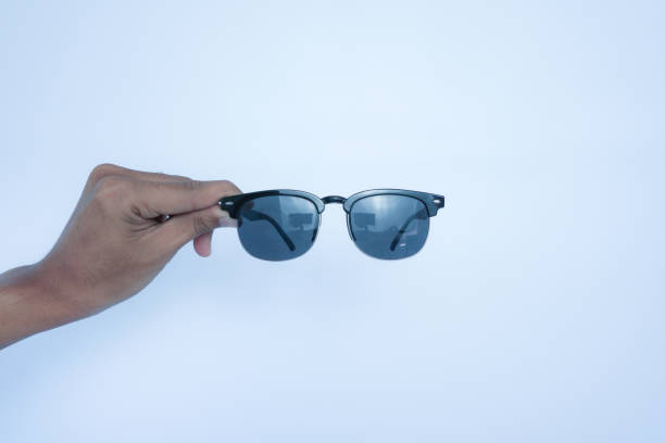 istock hands holding black glasses on white background 2161868419