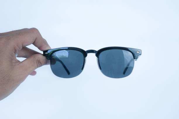 istock hands holding black glasses on white background 2161868421