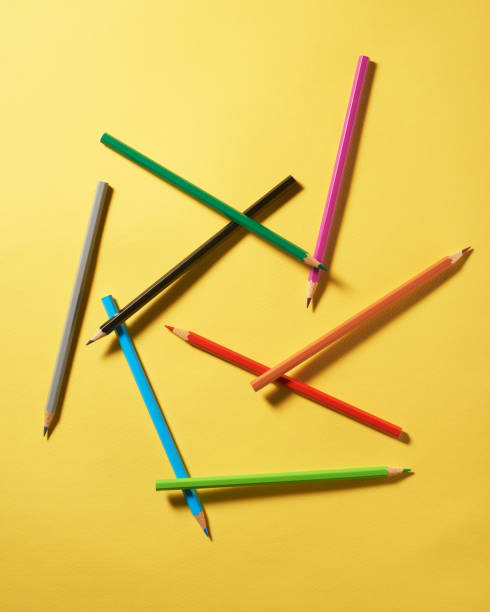 istock Colored pencils on yellow paper background 2161870333