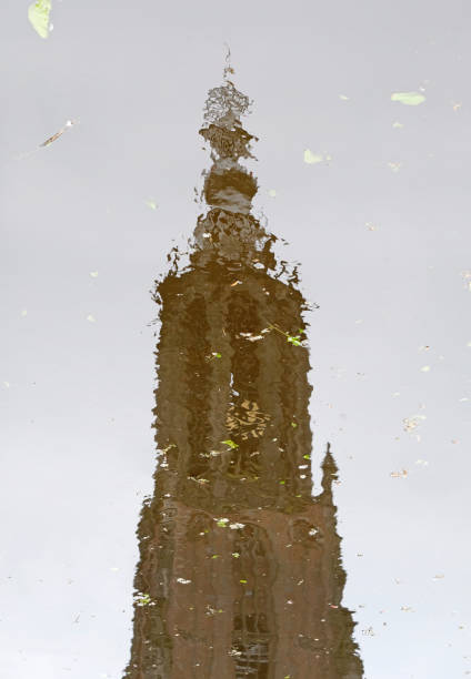 istock Church tower mirrored in a puddle 2161870547