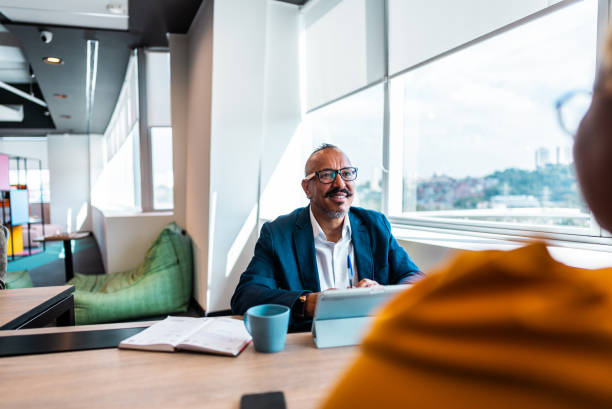 istock Businessman talking with coworker on the office 2161871525