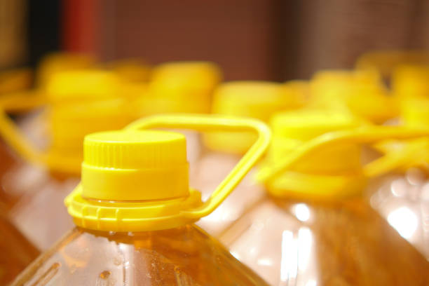 yellow sunflower oil bottle lined up in a store .