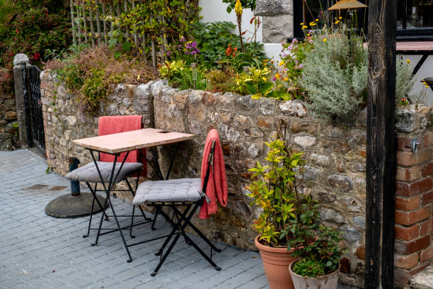 istock Outdoor table and chairs near a stone wall 2161881791