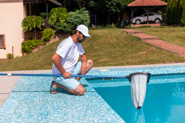 istock Man cleaning the swimming pool 2161882455