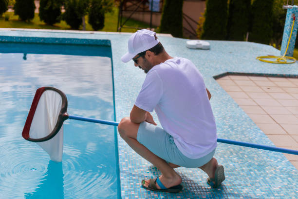 istock Man cleaning the swimming pool 2161882456