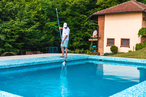 Man cleaning the swimming pool