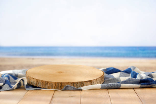 istock Checkered table cloth on empty wooden table with tropical beach abckground. 2161890552