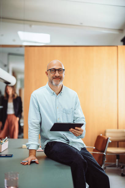 Confident Businessman with Tablet in Modern Office Environment