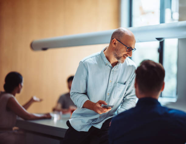 Business Team Socializing During Break In Modern Office