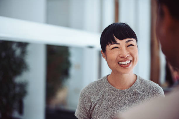 istock Smiling Woman Having A Friendly Conversation Indoors 2161896300