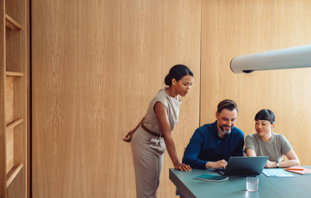 Diverse Team Collaborating At Modern Workplace During Meeting