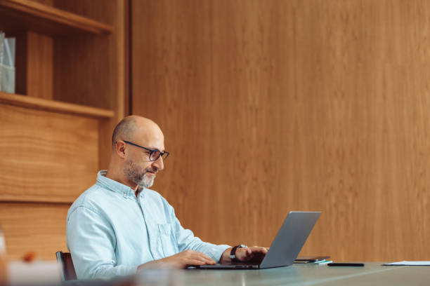 Professional Man Working on Laptop in Modern Office Setting