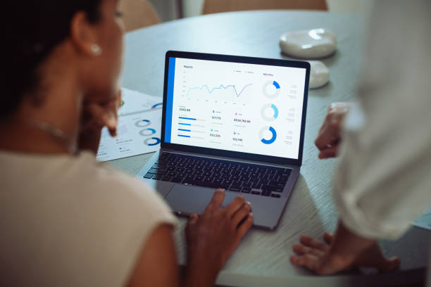 istock Businesswomen Analyzing Sales Data on Laptop in Office 2161896417
