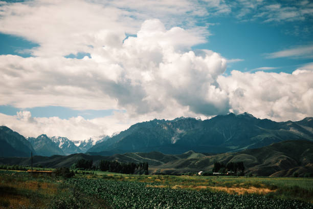 Cloudy skies above a verdant mountain gorge on a summer day