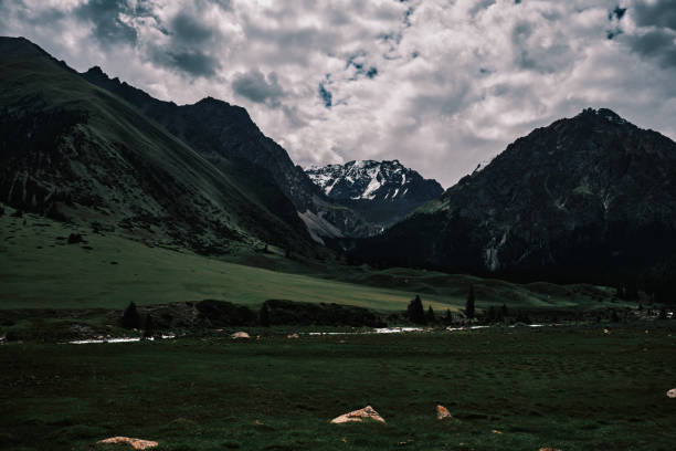 istock Verdant mountain gorge under a cloudy summer sky 2161898423