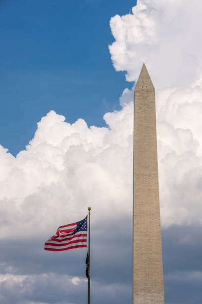 istock Washington DC - Washington Monument with Flag & Clouds 2161899715