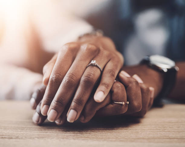istock Marriage, support and couple with holding hands on table for partnership, compassion and kindness. Care, trust and people with connection in love commitment for empathy, forgiveness and understanding 2161900339