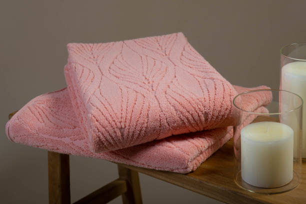 istock Folded Pink Towel on Wooden Table with Neutral Background 2161901562