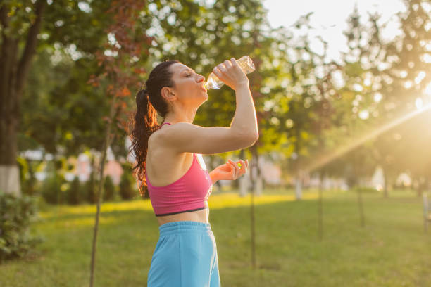 istock Active lifestyle. Woman drinking water. 2161902038