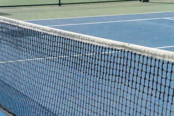 istock blue colored tennis court and net 2161903171