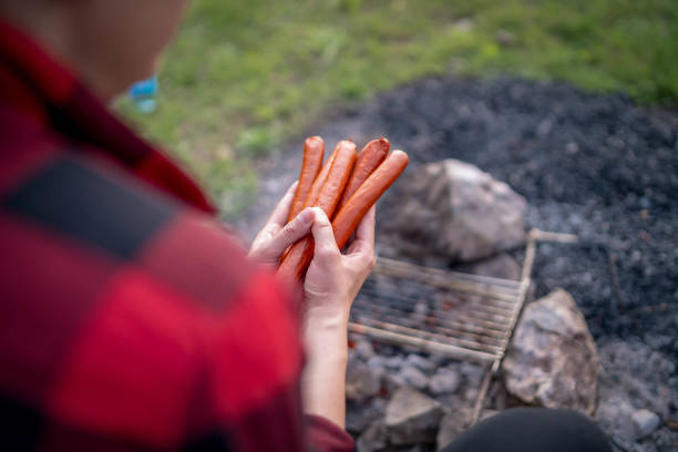 Young girl preparing food on grill