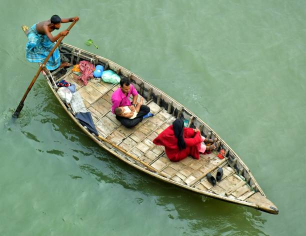 Sadarghat, Dhaka, Bangladesh, 13 June 2024: Aerial view of people crossing River on small boat