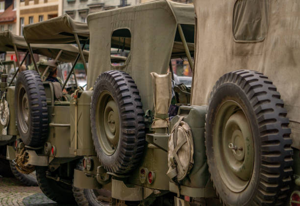 the back of an old off-road military vehicle, a spare tire and a medical package American military equipment from the Second World War. jeep, off-road vehicles with equipment. military equipment show in the city on the street. antique military equipment jeep 4x4 off road vehicle world war ii stock pictures, royalty-free photos & images