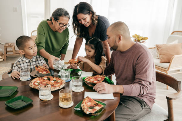 istock Multi-ethnic family having pizza for lunch 2161927228