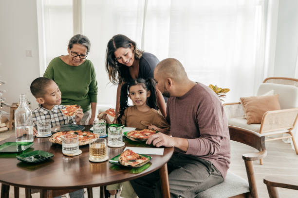 istock Multi-ethnic family having pizza for lunch 2161927235