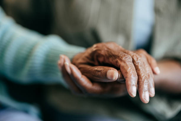 istock Young woman holding elderly hands 2161927253