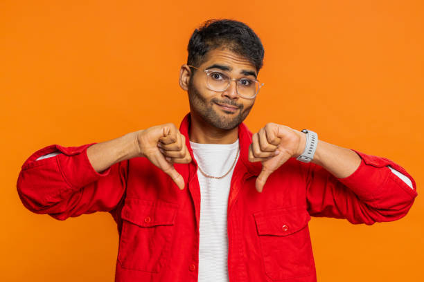 istock Upset man guy showing thumbs down gesture disapproval dissatisfied dislike negative feedback 2161927384