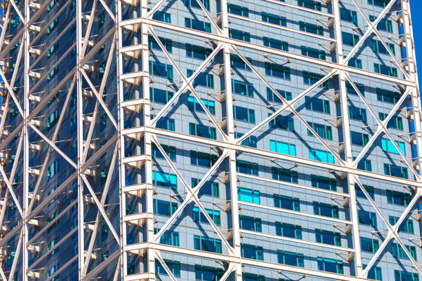 Building is made of metal and has a modern design. Majestic tall building with many windows in city center