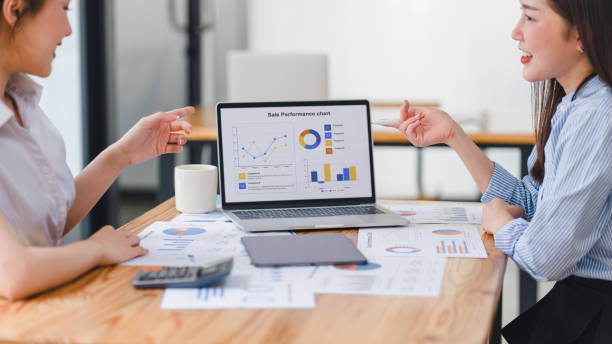 istock Two businesspeople or an accountant team are analyzing data charts, graphs, and a dashboard on a laptop screen in order to prepare a statistical report and discuss financial data in an office. 2161929582
