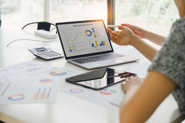 istock Two businesspeople or an accountant team are analyzing data charts, graphs, and a dashboard on a laptop screen in order to prepare a statistical report and discuss financial data in an office. 2161929585