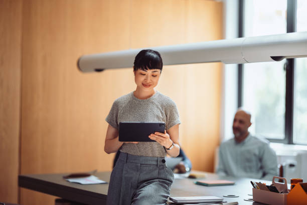 istock Japanese Businesswoman Working with Tablet in Modern Office Setting (Copy Space) 2161932045