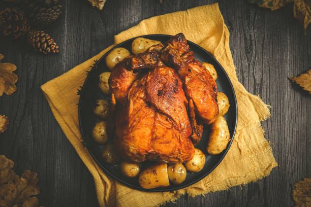 istock Chicken with potatoes in a dish on a black wooden table. 2161934250