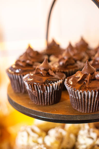 istock Chocolate cupcakes with chocolate frosting on dessert tower 2161937084