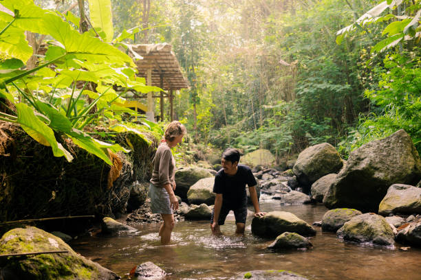 istock Two Diverse People Having Fun Bathing in Shallow River 2161938966