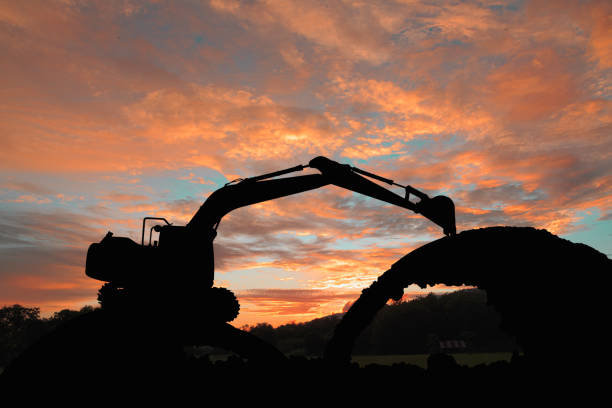 istock Excavators silhouette are digging the soil in the construction site 2161943054