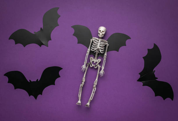 istock Halloween Skeleton with Bat Wings on Purple Background 2161944941