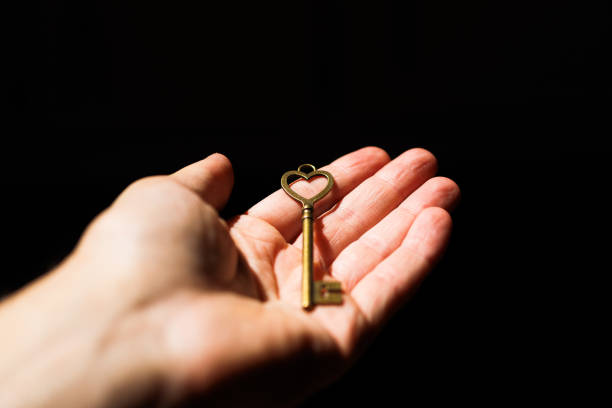 Woman's hand opening padlock with key