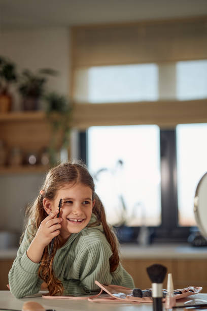 istock Happy girl applying make up 2161948103