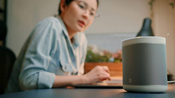 istock Woman Using Smart Speaker in Home Office 2161950147