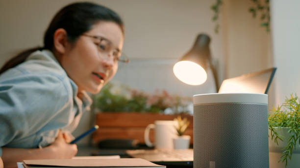 istock Woman Using Smart Speaker in Home Office 2161950149